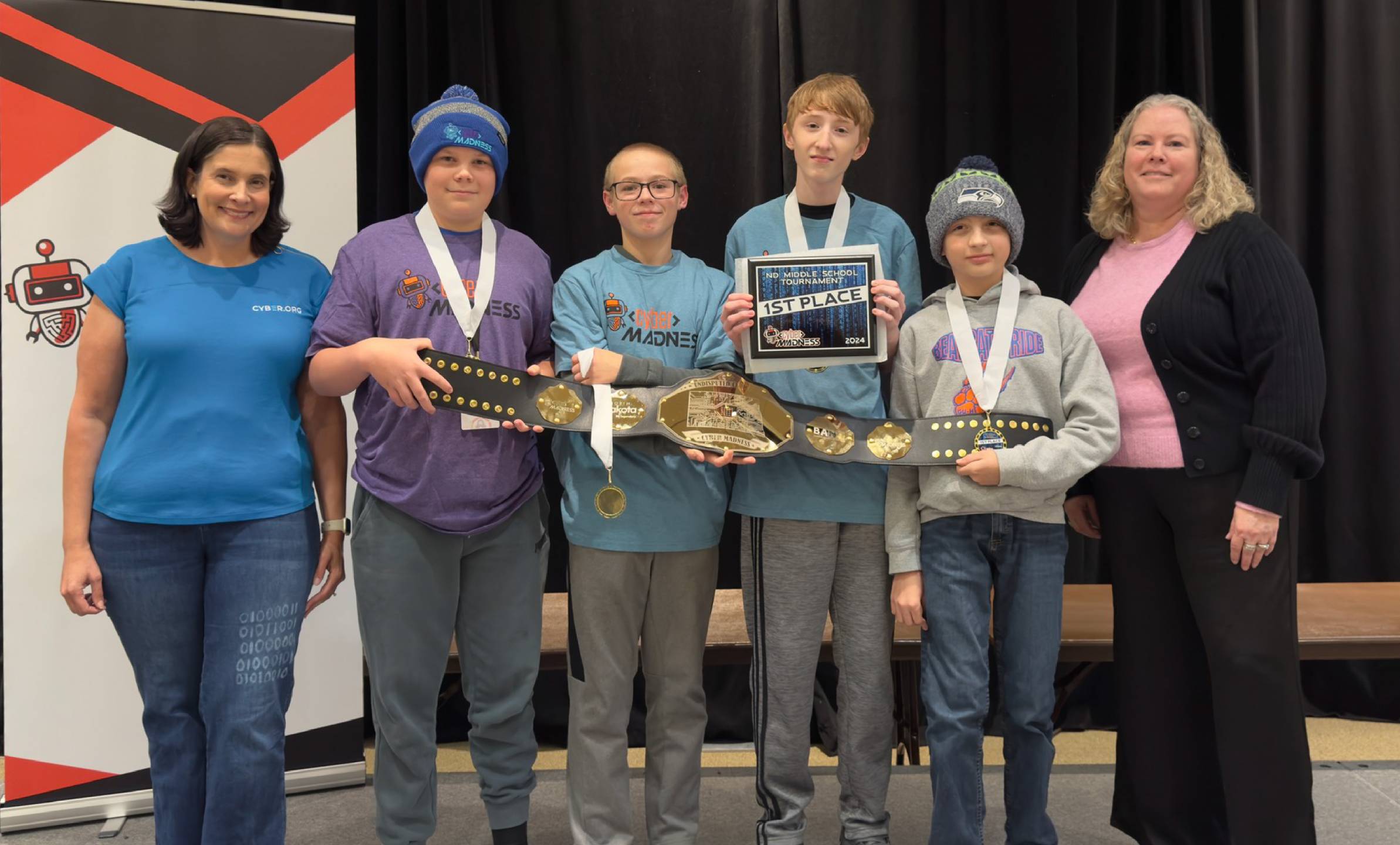 The first place championship team, the Cyberbearcats from Glen Ullin, holding up the championship belt